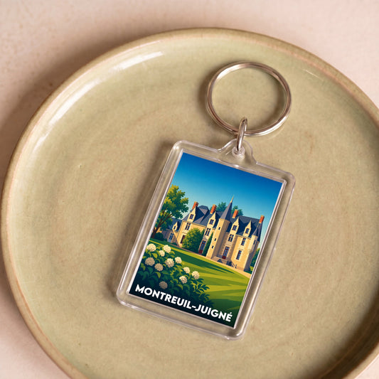Porte-clés souvenir de la ville de Montreuil-Juigné avec une illustration stylisée de château.
