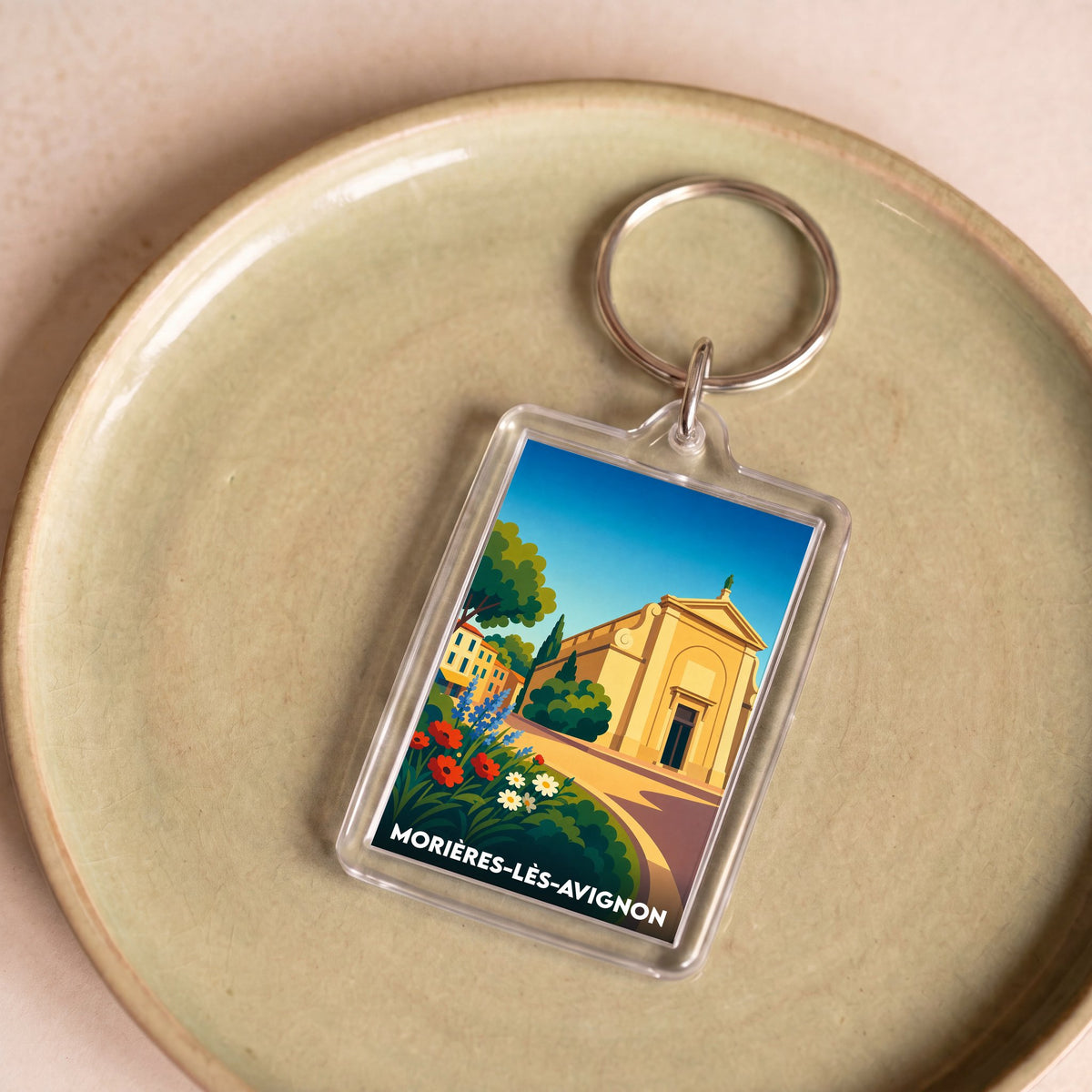 Porte-clés souvenir de la ville de Morières-lès-Avignon avec une illustration stylisée.
