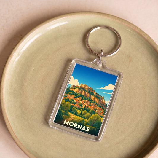 Porte-clés souvenir de la ville de Mornas avec une illustration stylisée de sa forteresse et de son village.