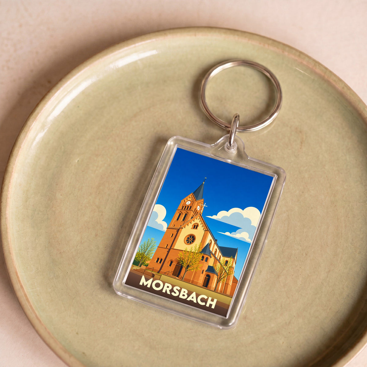 Porte-clés souvenir de la ville de Morsbach avec une illustration stylisée d'une église.