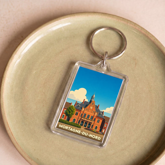 Porte-clés souvenir de la ville de Mortagne-du-Nord avec une illustration stylisée de son hôtel de ville.