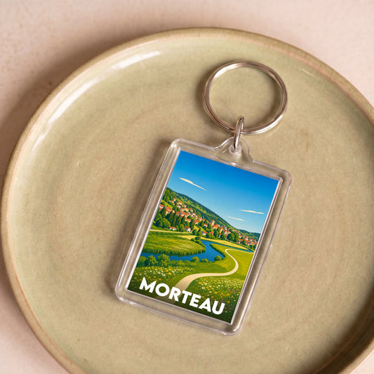 Porte-clés souvenir de la ville de Morteau avec une illustration paysagère stylisée.