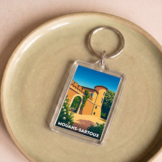 Porte-clés souvenir de la ville de Mouans-Sartoux avec une illustration stylisée de son château.