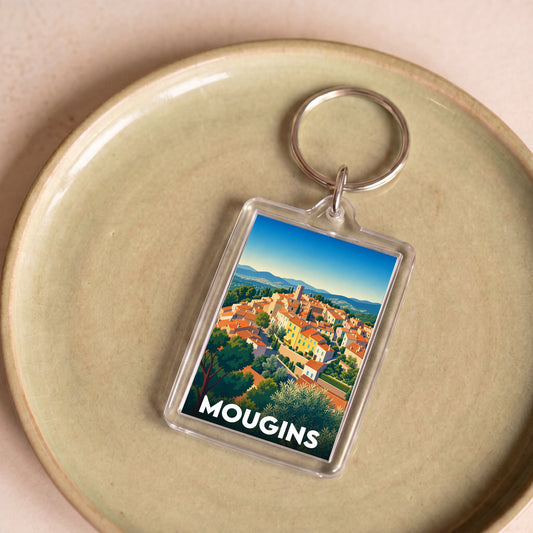 Porte-clés souvenir de la ville de Mougins avec une illustration stylisée du village.