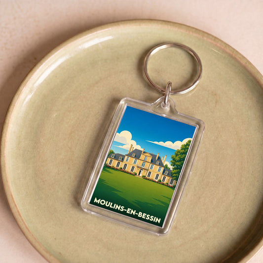 Porte-clés souvenir de la ville de Moulins-en-Bessin avec une illustration stylisée d'un château.
