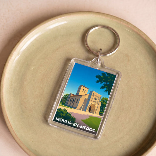 Porte-clés souvenir de la ville de Moulis-en-Médoc avec une illustration stylisée.