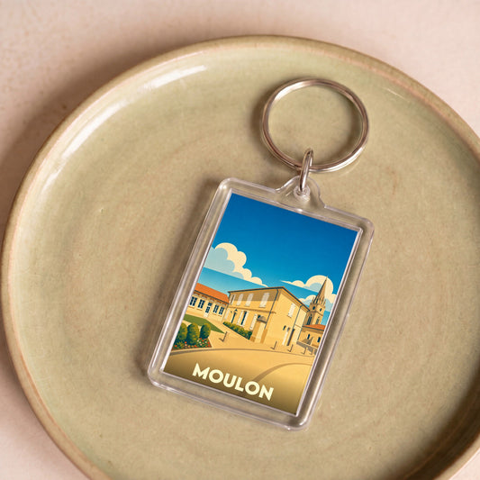 Porte-clés souvenir de la ville de Moulon avec une illustration stylisée.