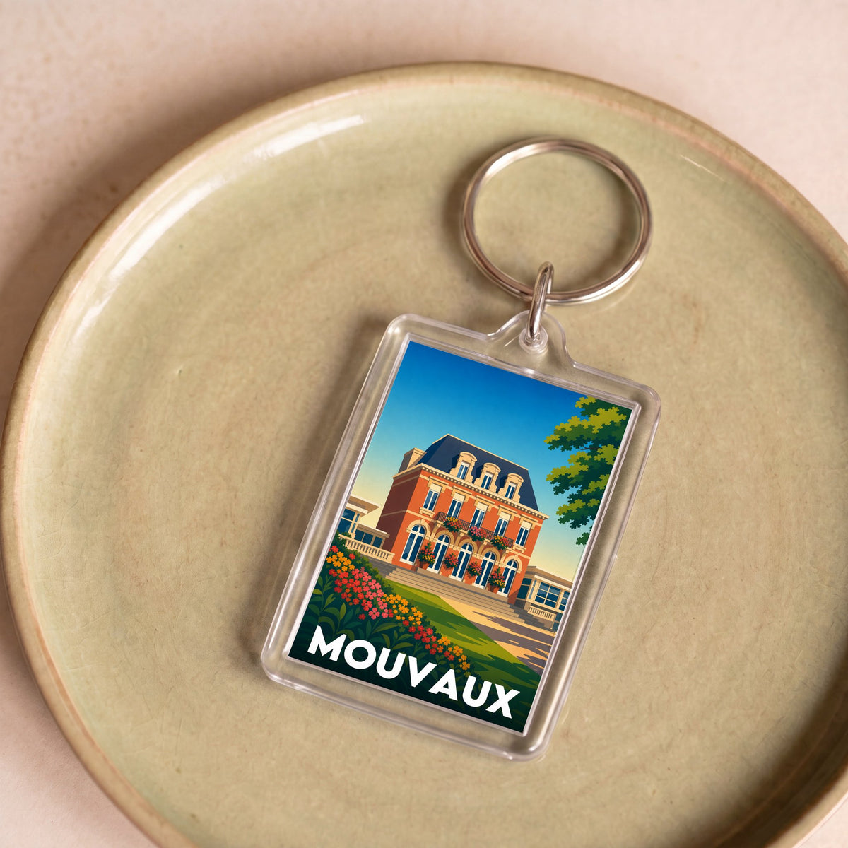 Porte-clés souvenir de la ville de Mouvaux avec une illustration stylisée.