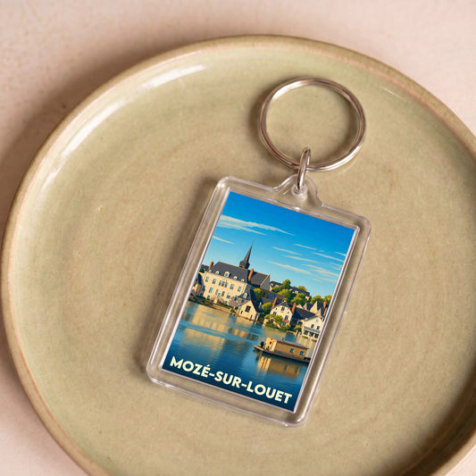 Porte-clés souvenir de la ville de Mozé-sur-Louet avec une illustration stylisée.