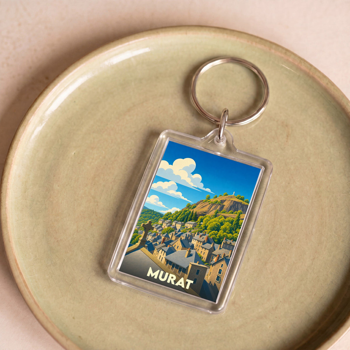 Porte-clés souvenir de la ville de Murat avec une illustration stylisée.