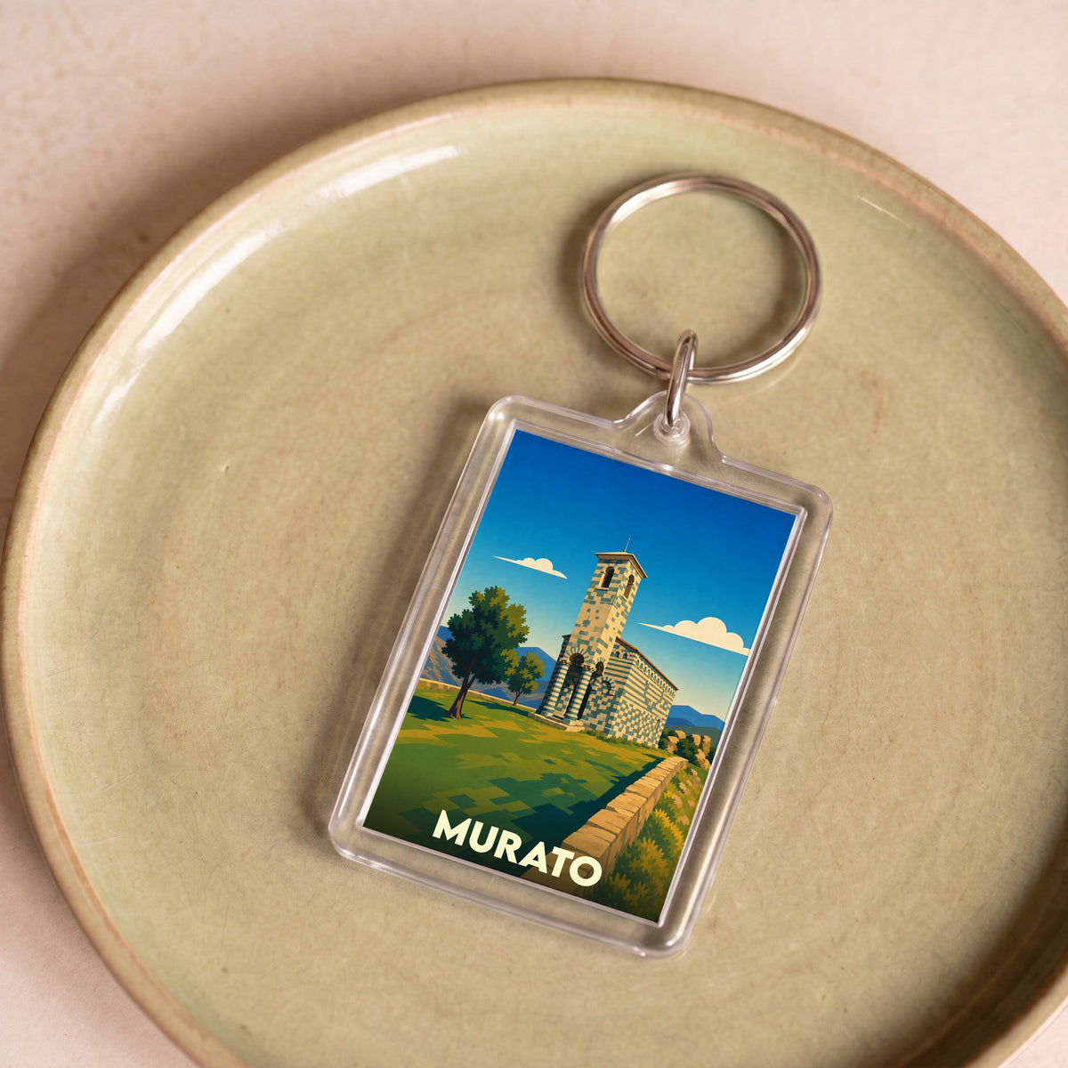 Porte-clés souvenir de la ville de Murato avec une illustration stylisée de son église romane.