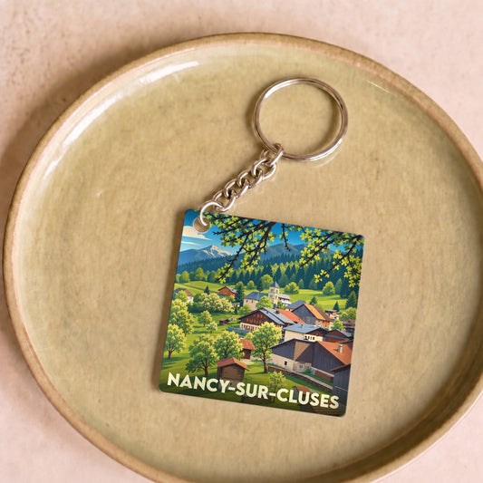 Porte-clés souvenir de Nancy-sur-Cluses avec une illustration paysagère stylisée.