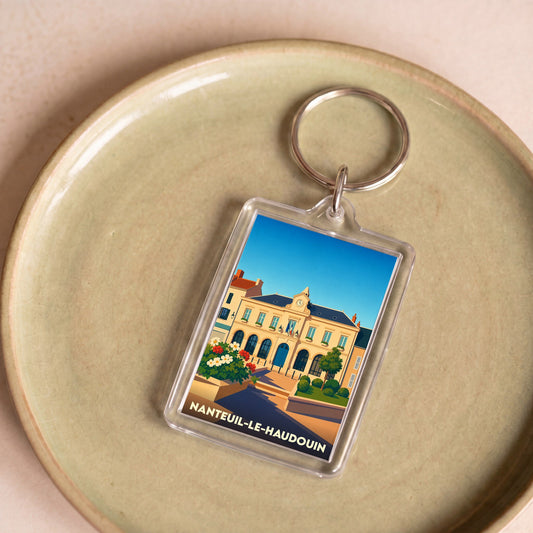 Porte-clés souvenir de la ville de Nanteuil-le-Haudouin avec une illustration stylisée de la mairie.