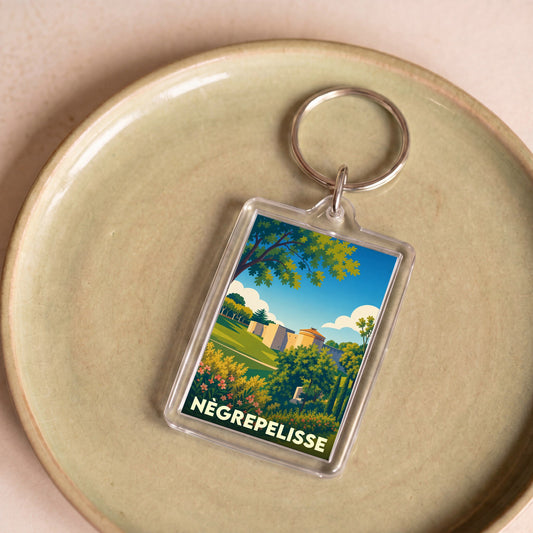 Porte-clés souvenir de la ville de Nègrepelisse avec une illustration stylisée.