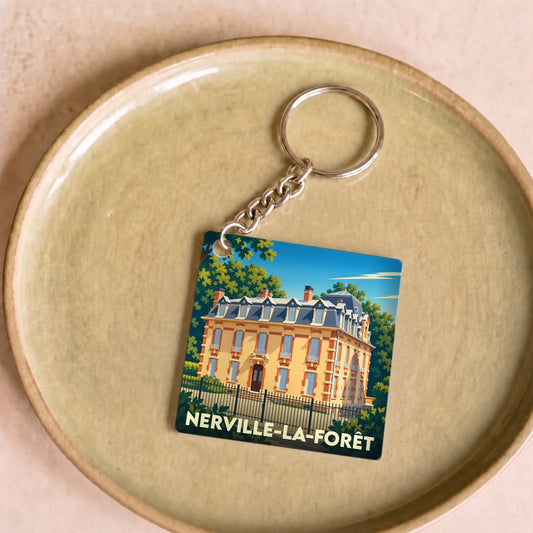 Porte-clés souvenir de la ville de Nerville-la-Forêt avec une illustration stylisée d'une demeure bourgeoise.