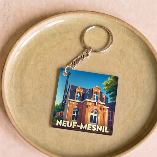 Porte-clés souvenir de la ville de Neuf-Mesnil avec une illustration stylisée de sa mairie.