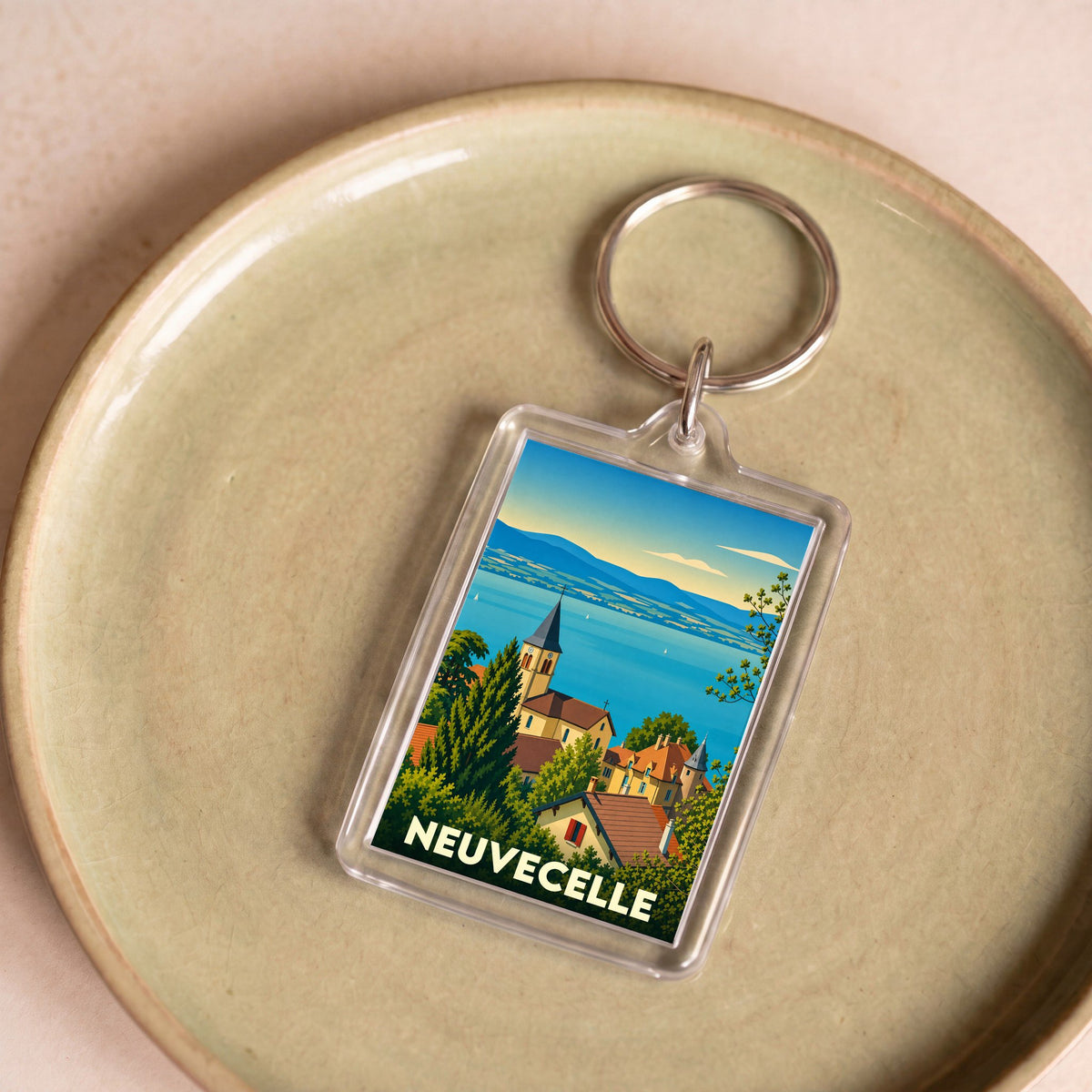 Porte-clés souvenir de la ville de Neuvecelle avec une illustration stylisée.
