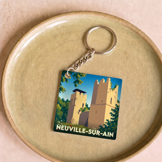 Porte-clés souvenir de la ville de Neuville-sur-Ain avec une illustration stylisée.