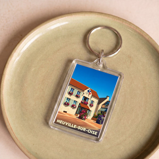 Porte-clés souvenir de la ville de Neuville-sur-Oise avec une illustration stylisée de sa mairie.