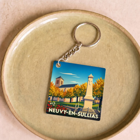 Porte-clés souvenir de la ville de Neuvy-en-Sullias avec une illustration stylisée.