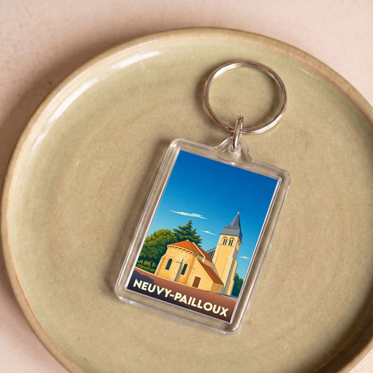 Porte-clés souvenir de la ville de Neuvy-Pailloux avec une illustration stylisée de son église.