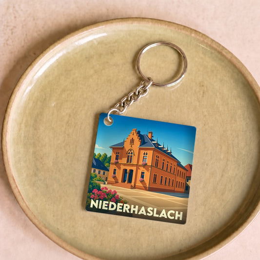 Porte-clés souvenir de la ville de Niederhaslach avec une illustration stylisée.