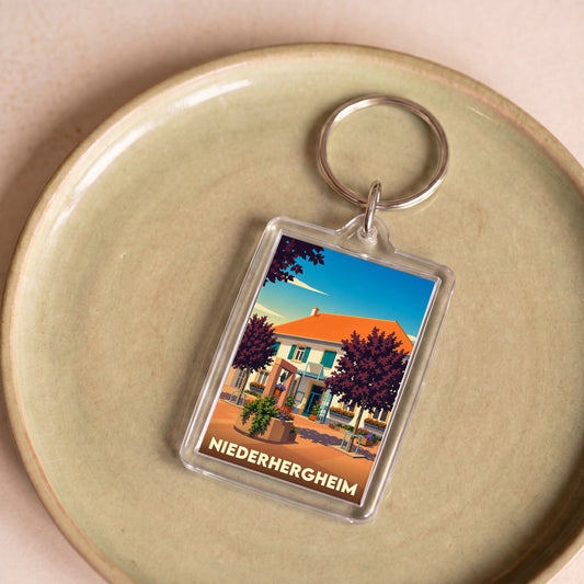 Porte-clés souvenir de la ville de Niederhergheim avec une illustration stylisée.