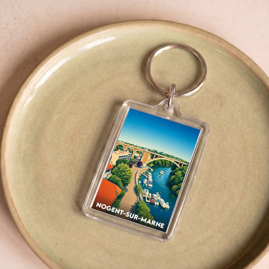 Porte-clés souvenir de la ville de Nogent-sur-Marne avec une illustration stylisée des bords de Marne.