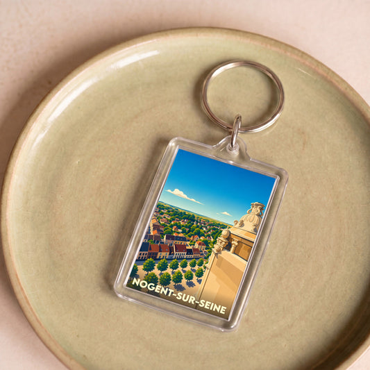 Porte-clés souvenir de la ville de Nogent-sur-Seine avec une illustration stylisée.