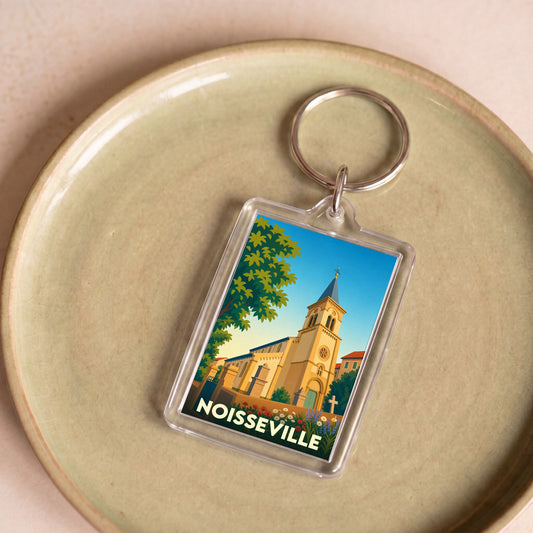 Porte-clés souvenir de la ville de Noisseville avec une illustration stylisée de son église.