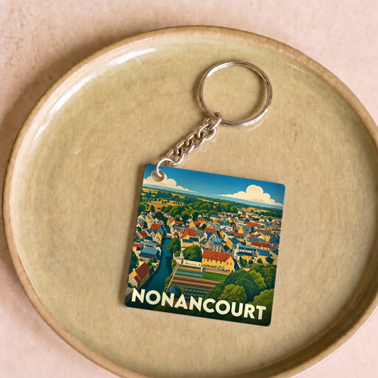 Porte-clés souvenir de la ville de Nonancourt avec une illustration stylisée.