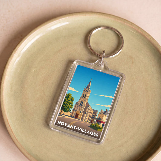 Porte-clés souvenir de la ville de Noyant-Villages avec une illustration stylisée.