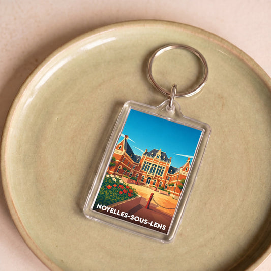 Porte-clés souvenir de la ville de Noyelles-sous-Lens avec une illustration stylisée de son patrimoine.