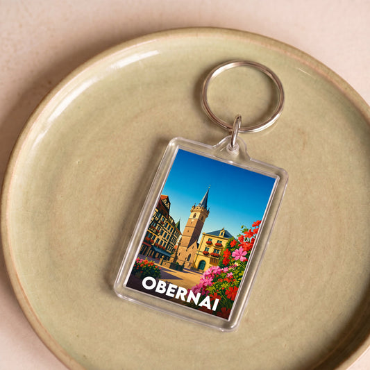 Porte-clés souvenir de la ville d'Obernai avec une illustration colorée et stylisée.