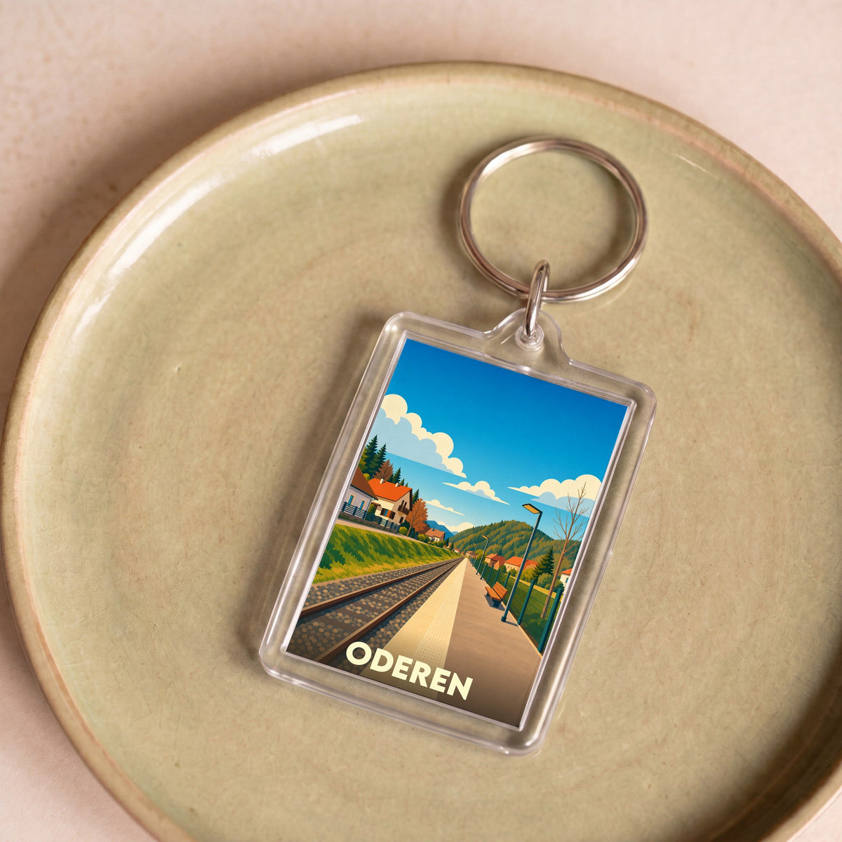 Porte-clés souvenir de la ville d'Oderen avec une illustration stylisée de sa gare.