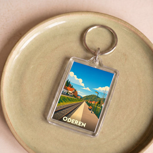 Porte-clés souvenir de la ville d'Oderen avec une illustration stylisée de sa gare.