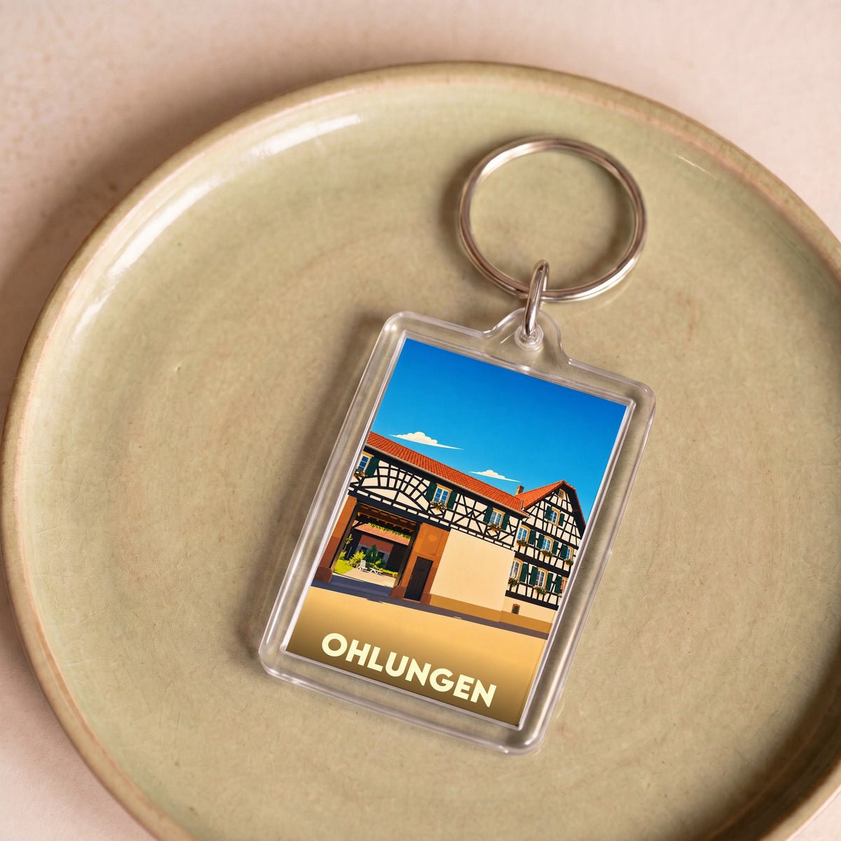 Porte-clés souvenir de la ville de Ohlungen avec une illustration stylisée d'une maison à colombages.