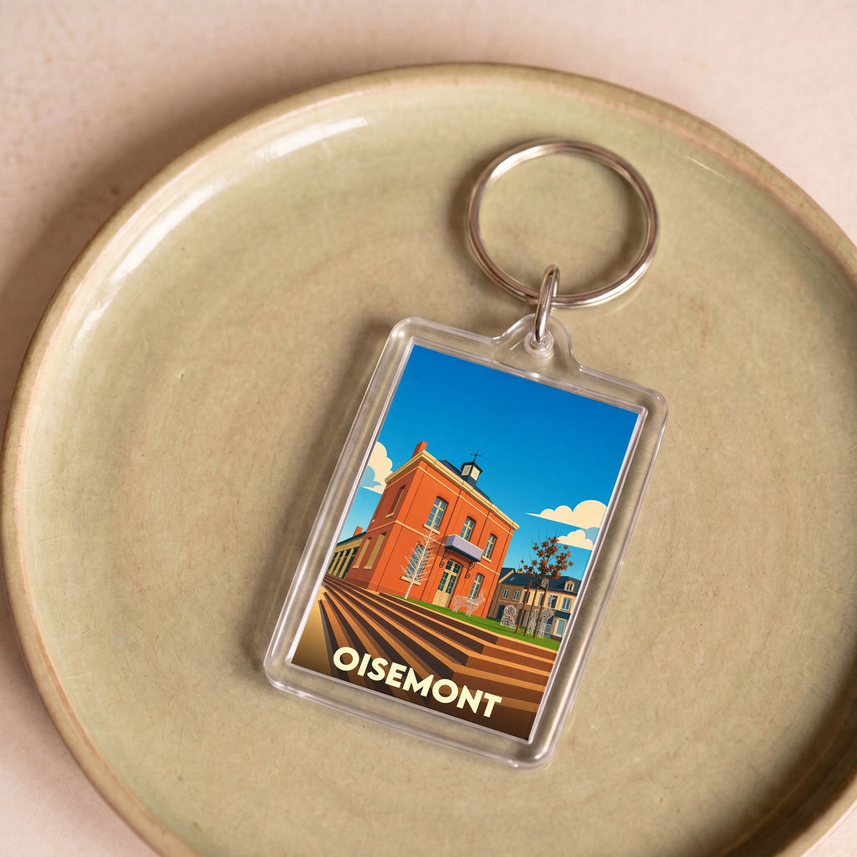 Porte-clés souvenir de la ville de Oisemont avec une illustration colorée et stylisée.