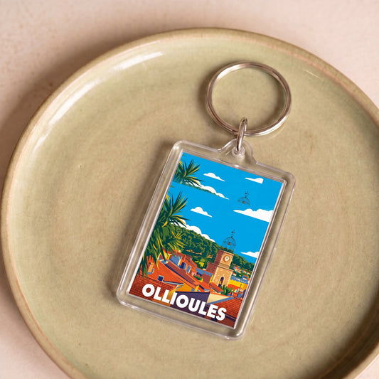 Porte-clés souvenir de la ville d'Ollioules avec une illustration stylisée et colorée.