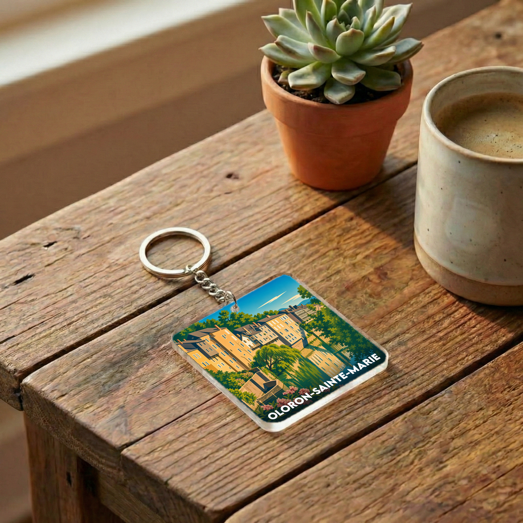Porte-clés souvenir de la ville de Oloron-Sainte-Marie avec une illustration stylisée.
