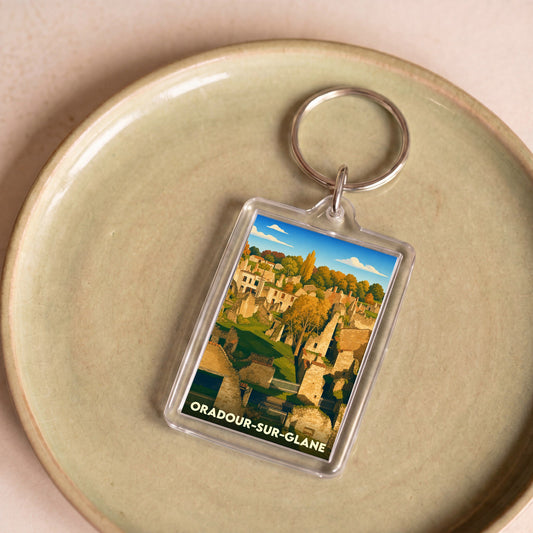 Porte-clés souvenir de la ville d'Oradour-sur-Glane avec une illustration stylisée de ses ruines historiques.