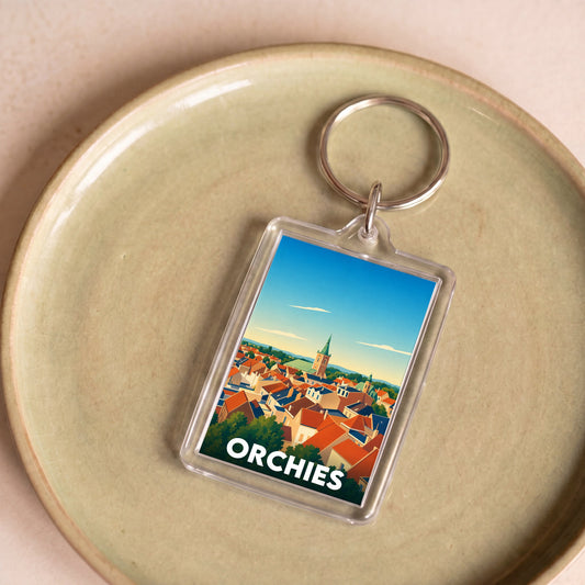 Porte-clés souvenir de la ville d'Orchies avec une illustration colorée et stylisée.