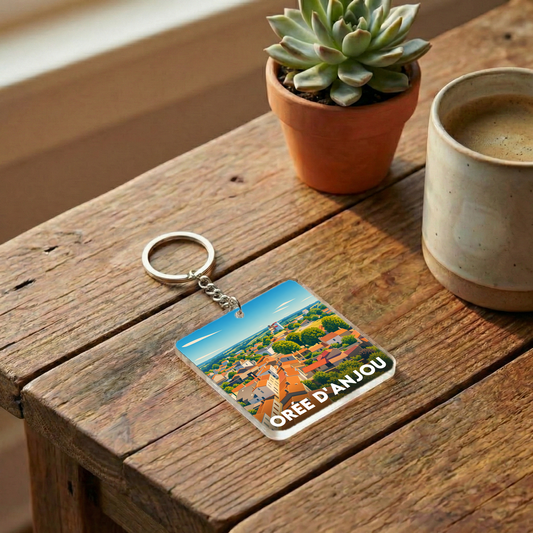 Porte-clés souvenir de la ville de Orée d'Anjou avec une illustration stylisée.