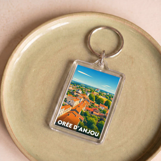Porte-clés souvenir de la ville de Orée d'Anjou avec une illustration stylisée.