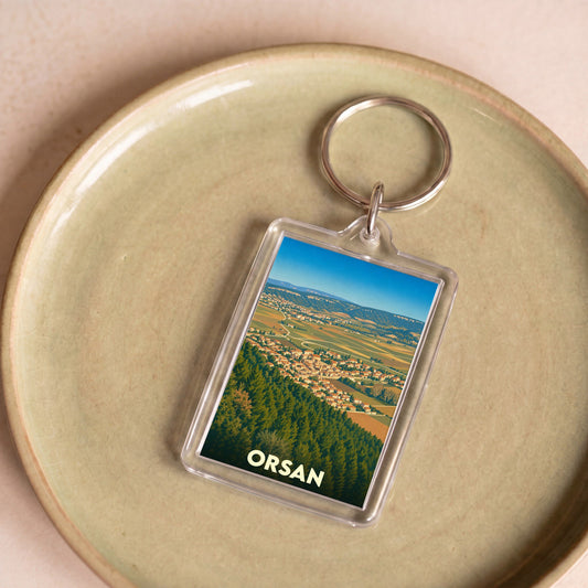 Porte-clés souvenir de la ville de Orsan avec une illustration stylisée.
