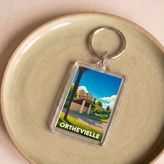 Porte-clés souvenir de la ville d'Orthevielle avec une illustration stylisée.