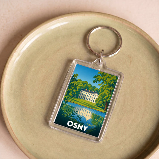 Porte-clés souvenir de la ville d'Osny avec une illustration stylisée d'un château au bord de l'eau.