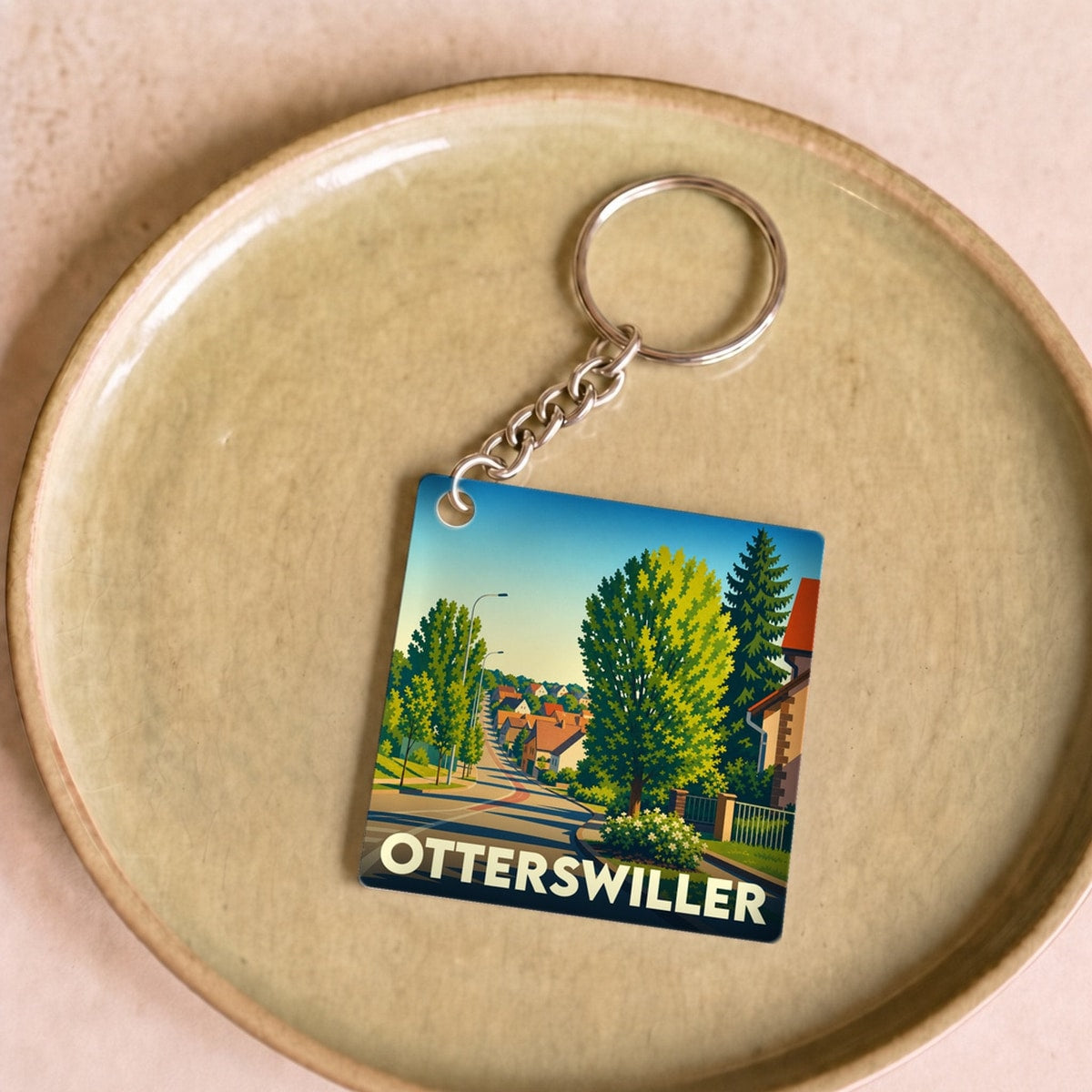 Porte-clés souvenir de la ville de Otterswiller avec une illustration stylisée.