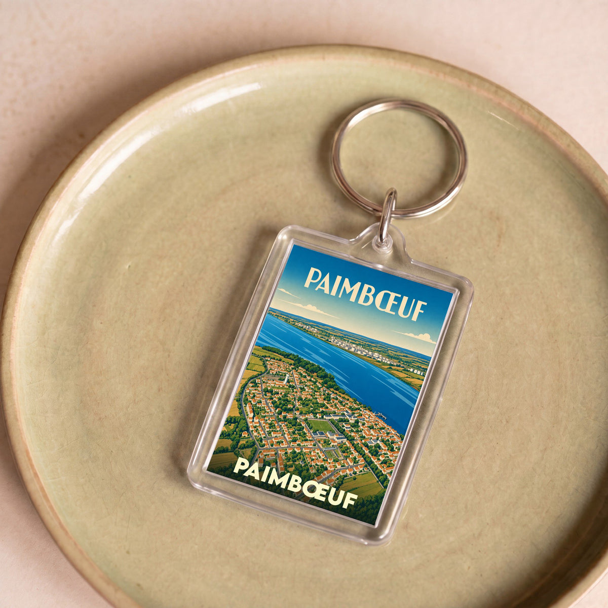Porte-clés souvenir de la ville de Paimbœuf avec une illustration aérienne stylisée.