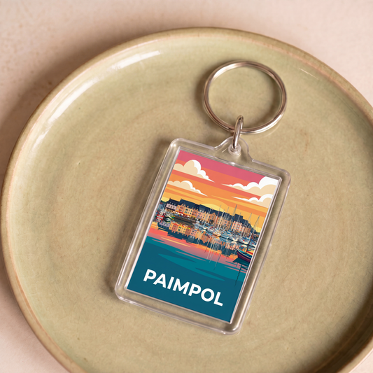 Porte-clés souvenir de la ville de Paimpol avec une illustration stylisée de son port au coucher du soleil.